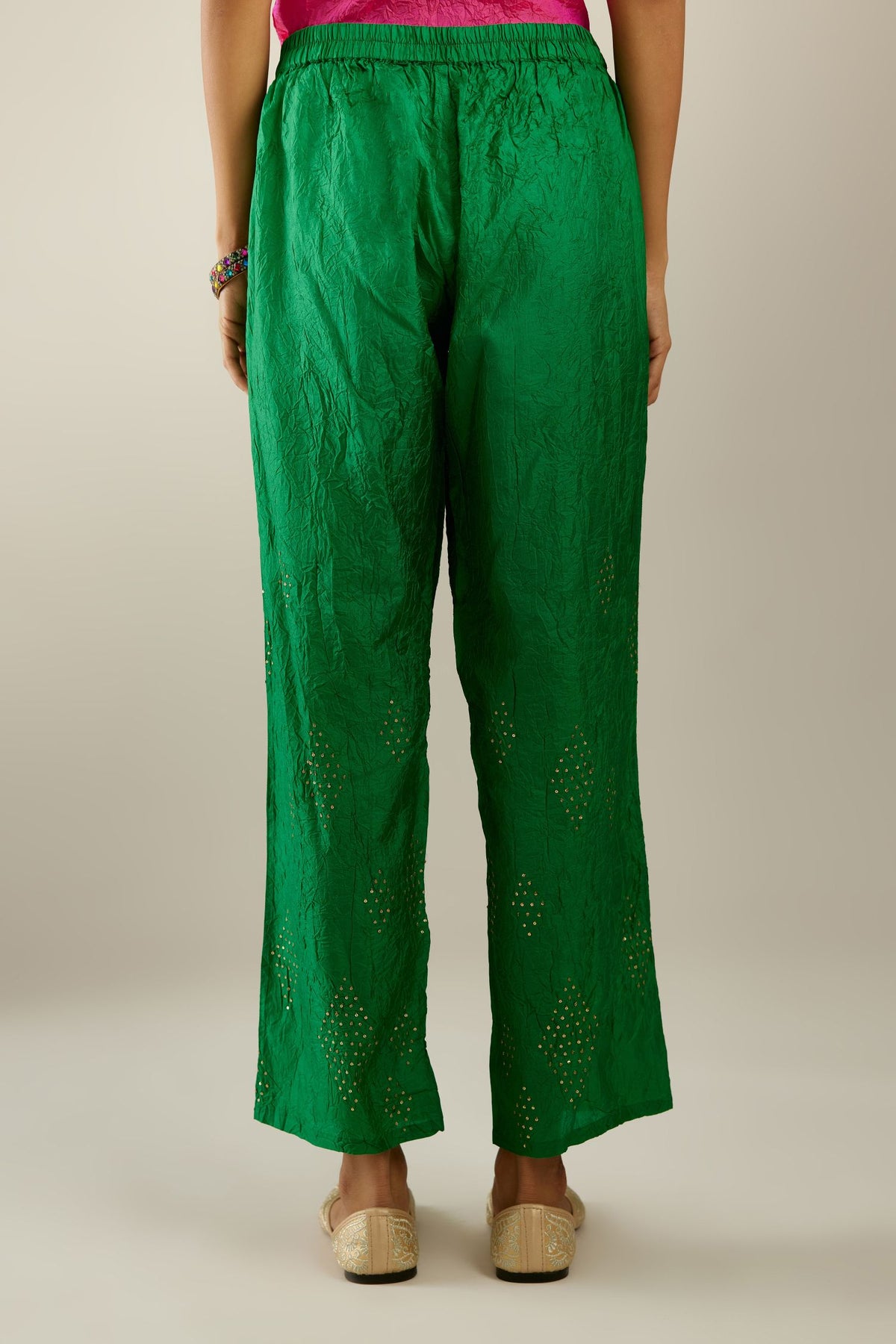 Grass green hand crushed pure silk straight pants with assorted diamond shape golden sequins work till knee length and side pockets.