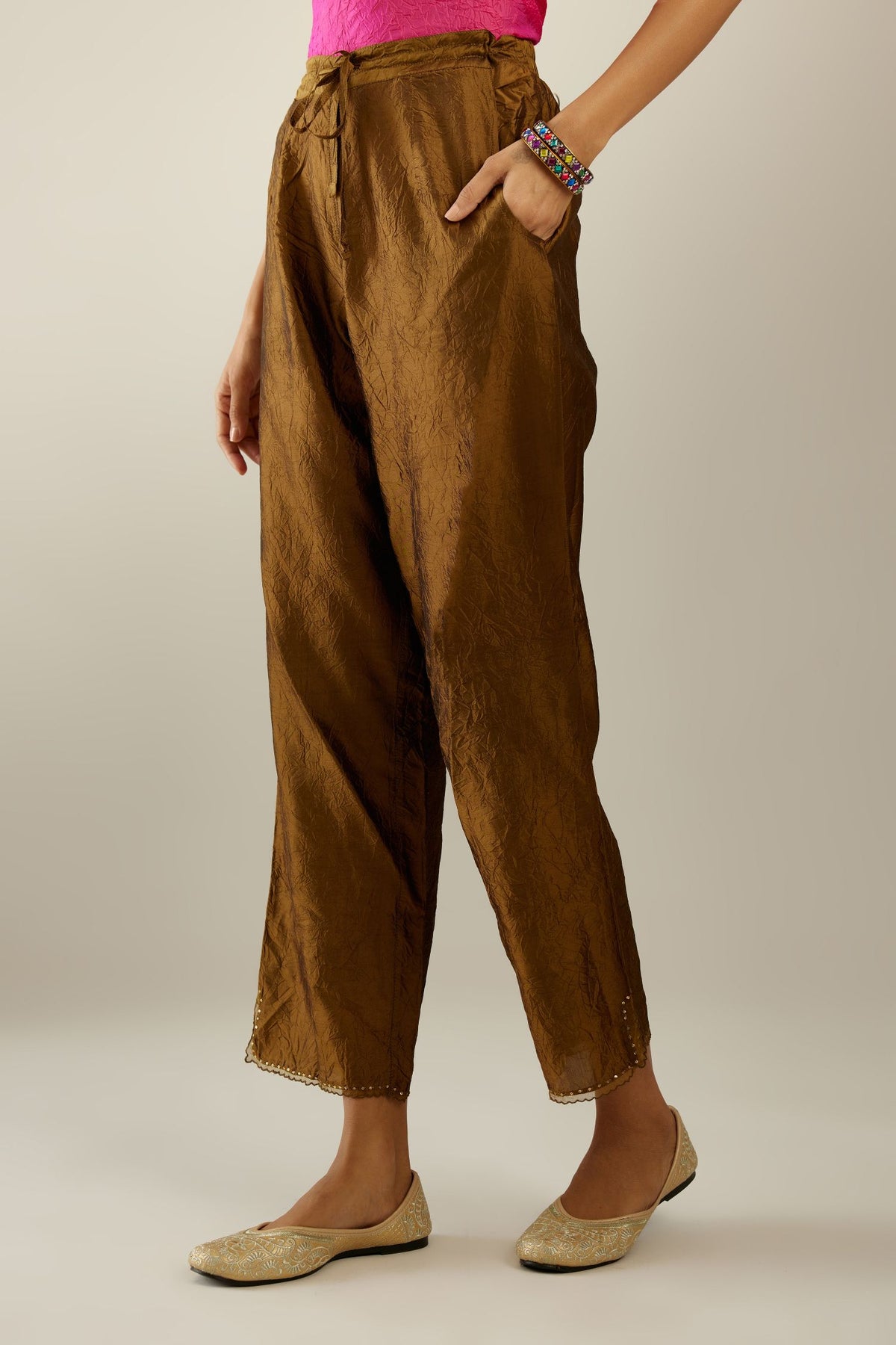 Golden olive hand crushed silk straight pants with scalloped and embroidered organza at edges and detailed with a single line of sequins at hem