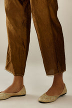 Golden olive hand crushed silk straight pants with scalloped and embroidered organza at edges and detailed with a single line of sequins at hem
