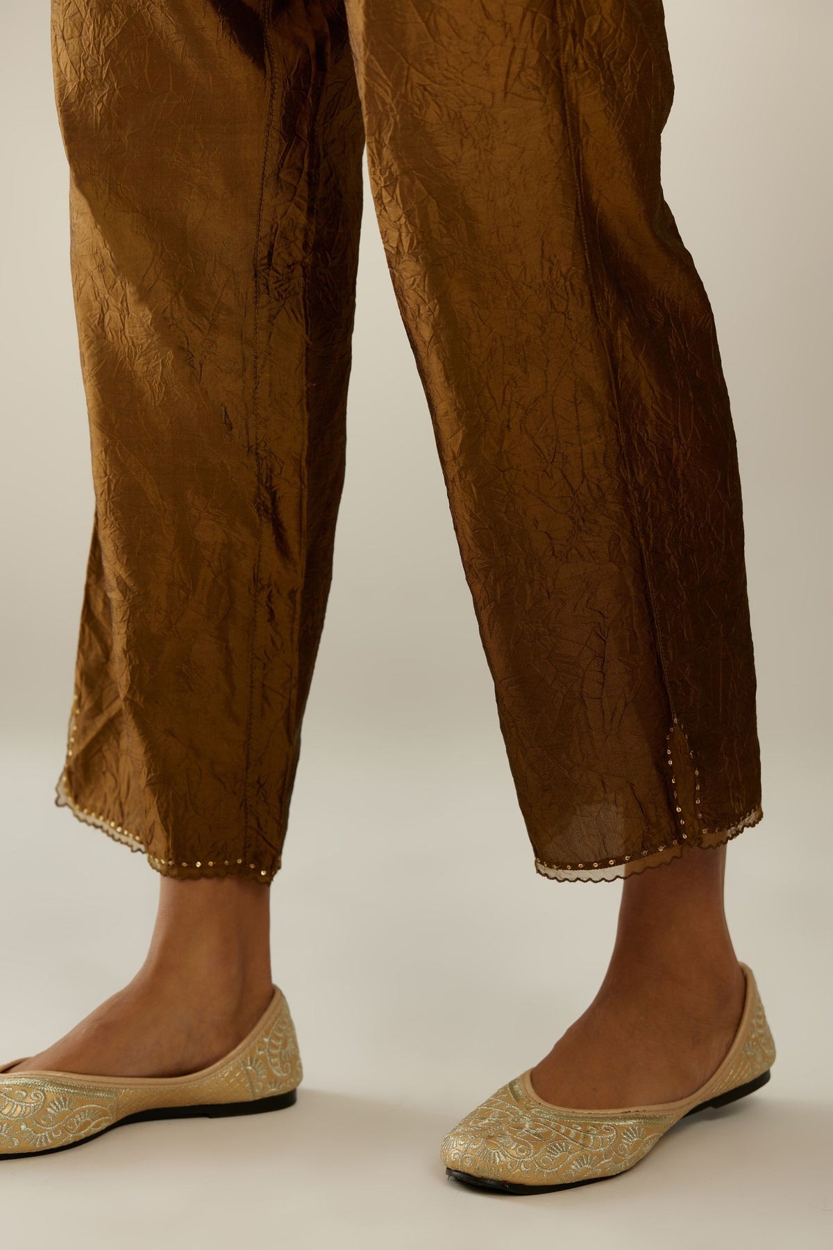 Golden olive hand crushed silk straight pants with scalloped and embroidered organza at edges and detailed with a single line of sequins at hem