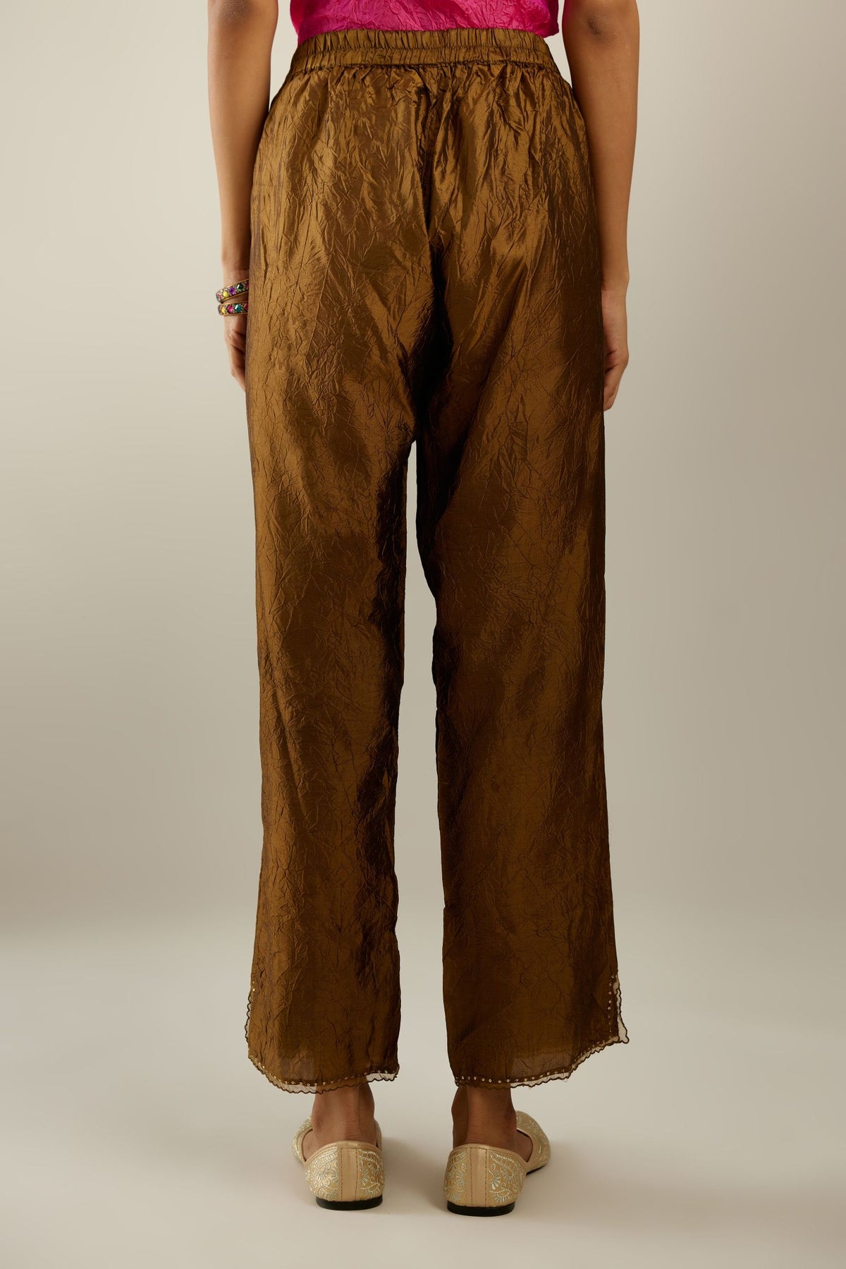 Golden olive hand crushed silk straight pants with scalloped and embroidered organza at edges and detailed with a single line of sequins at hem
