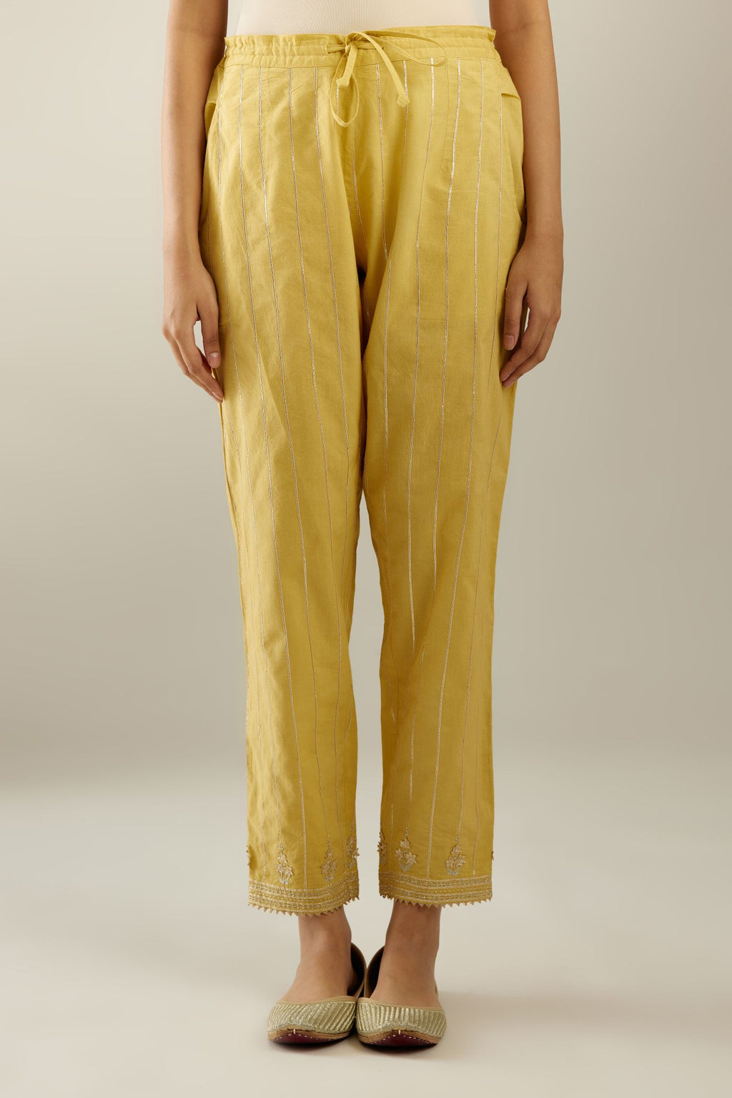 Yellow cotton straight pants with all-over gold gota lines and zari embroidery at hem.