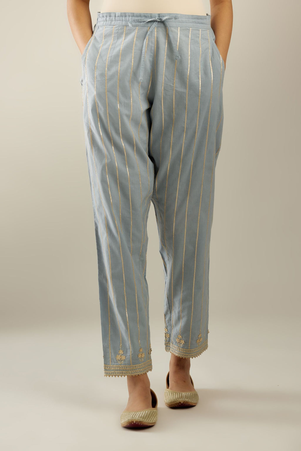 Blue cotton straight pants with all-over gold gota lines and zari embroidery at hem.