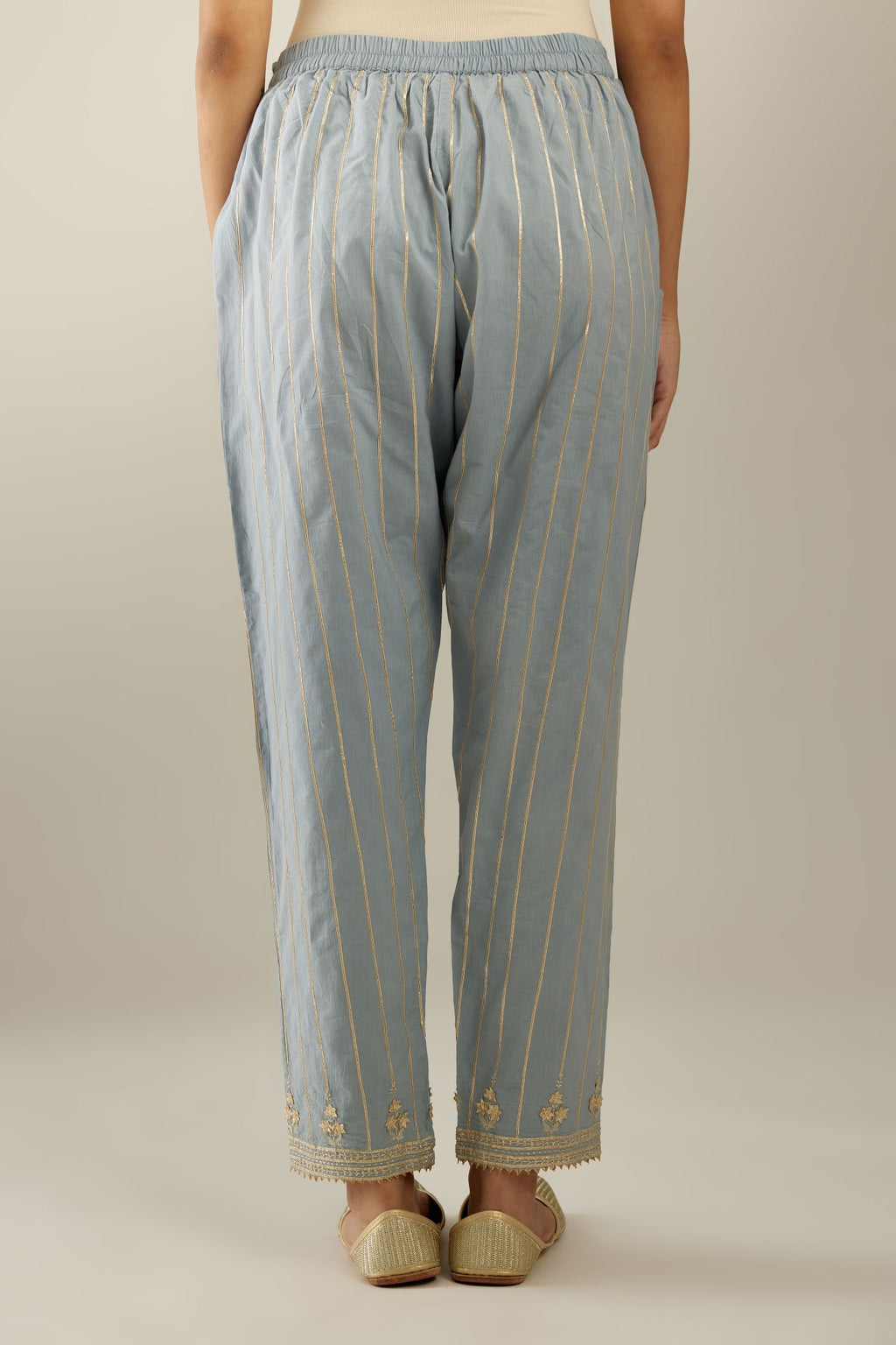Blue cotton straight pants with all-over gold gota lines and zari embroidery at hem.