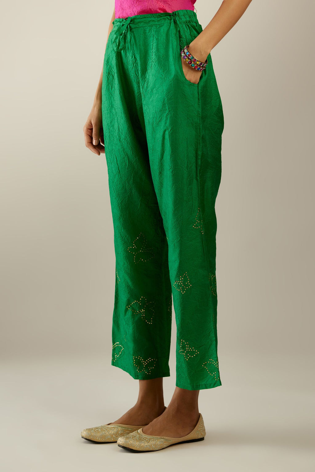 Grass green crushed silk pants with side pockets and assorted sequined butterflies till mid-calf length.