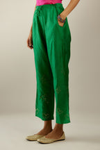 Grass green crushed silk pants with side pockets and assorted sequined butterflies till mid-calf length.