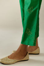 Grass green crushed silk pants with side pockets and assorted sequined butterflies till mid-calf length.