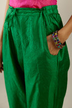 Grass green crushed silk pants with side pockets and assorted sequined butterflies till mid-calf length.