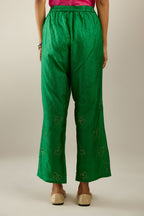 Grass green crushed silk pants with side pockets and assorted sequined butterflies till mid-calf length.