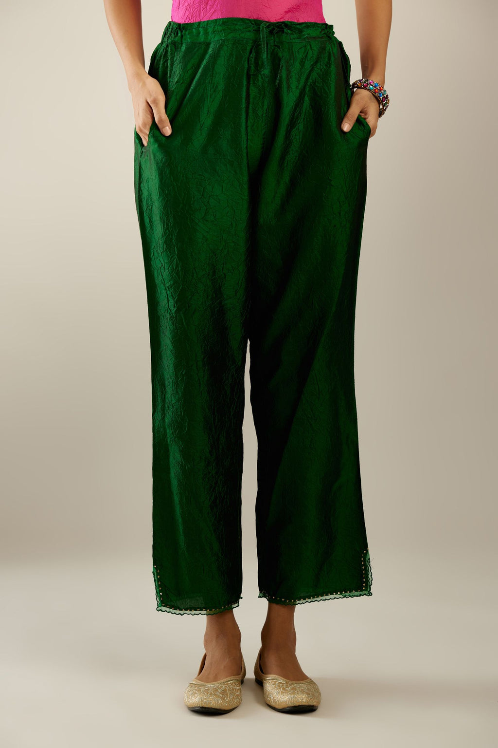 Dark green hand crushed silk straight pants with scalloped and embroidered organza at edges and detailed with a single line of sequins at hem