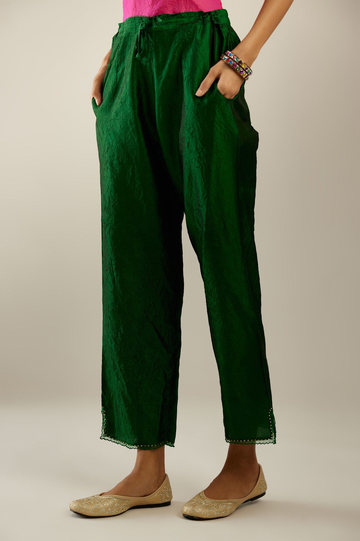 Dark green hand crushed silk straight pants with scalloped and embroidered organza at edges and detailed with a single line of sequins at hem