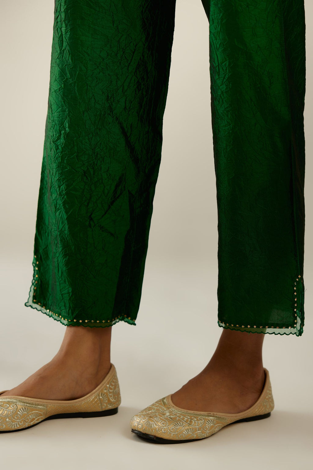 Dark green hand crushed silk straight pants with scalloped and embroidered organza at edges and detailed with a single line of sequins at hem