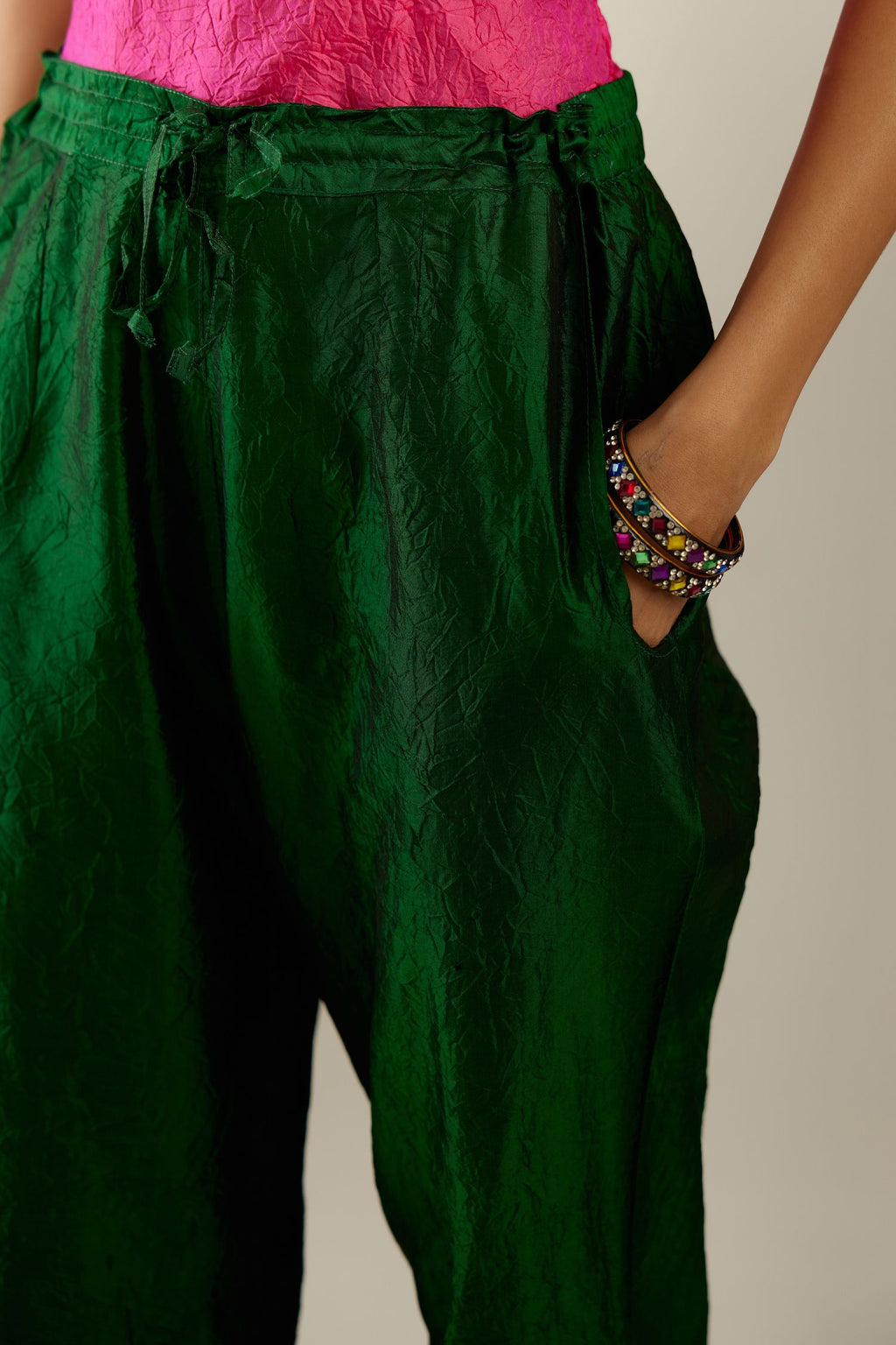 Dark green hand crushed silk straight pants with scalloped and embroidered organza at edges and detailed with a single line of sequins at hem