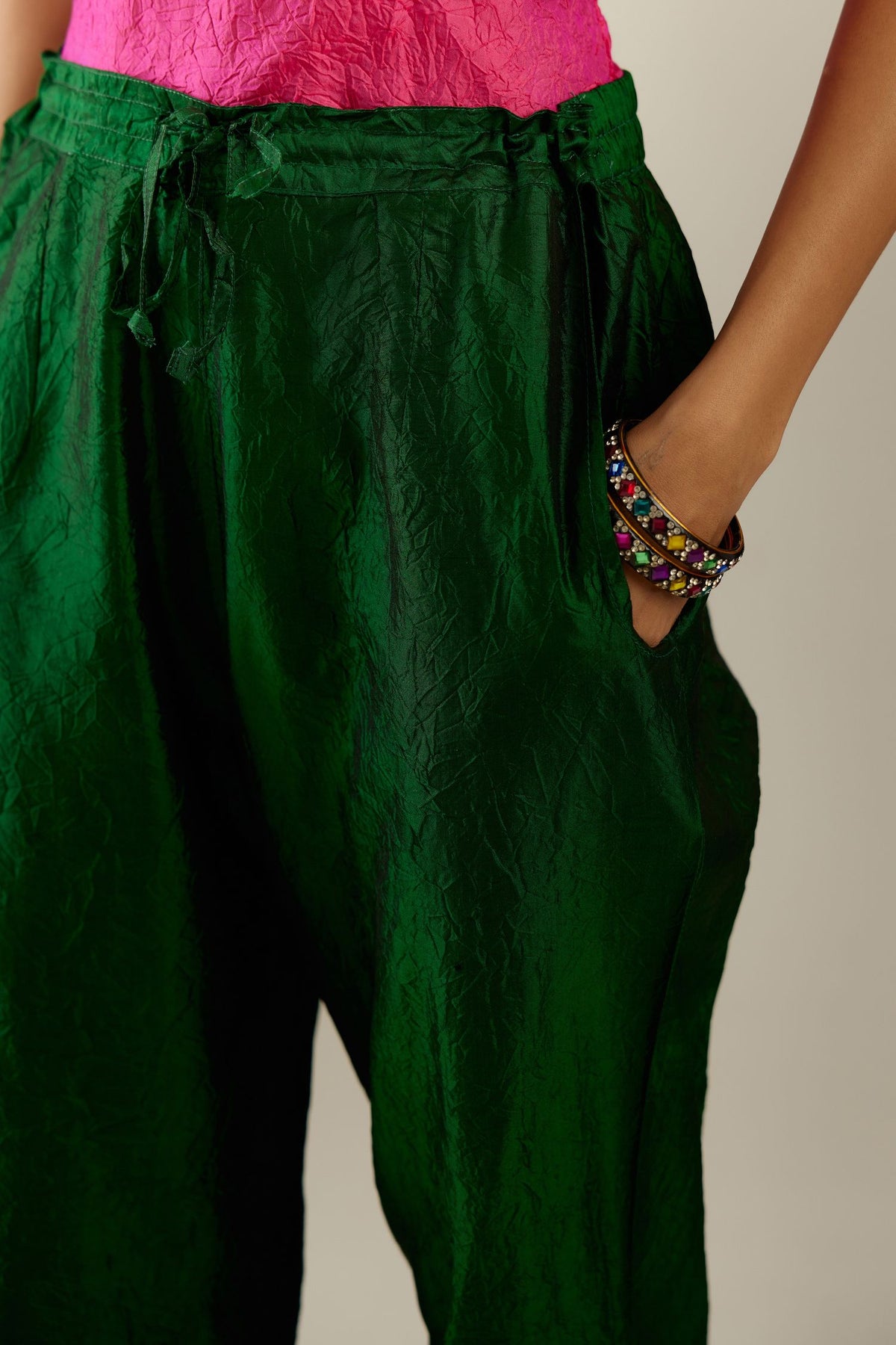 Dark green hand crushed silk straight pants with scalloped and embroidered organza at edges and detailed with a single line of sequins at hem