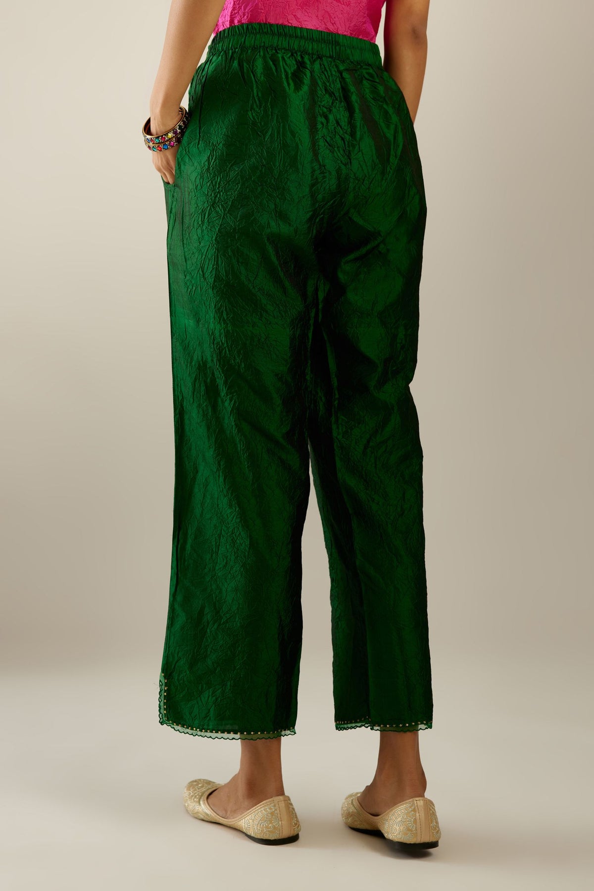 Dark green hand crushed silk straight pants with scalloped and embroidered organza at edges and detailed with a single line of sequins at hem