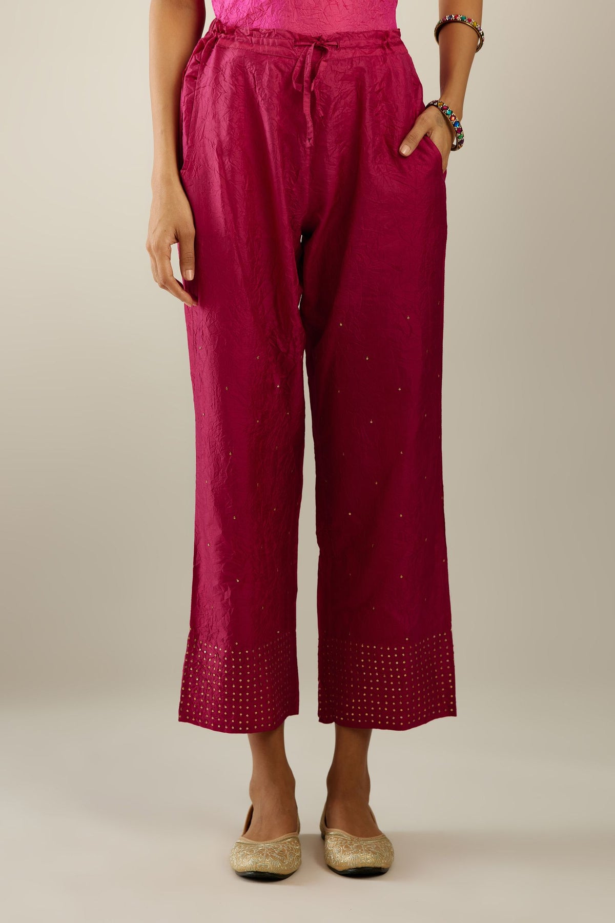 Jazzberry jam hand crushed silk straight pants detailed with gold sequins at hem and a single sequin buti is sprayed all over the pants and side pockets