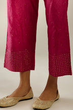 Jazzberry jam hand crushed silk straight pants detailed with gold sequins at hem and a single sequin buti is sprayed all over the pants and side pockets
