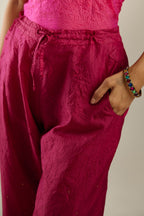 Jazzberry jam hand crushed silk straight pants detailed with gold sequins at hem and a single sequin buti is sprayed all over the pants and side pockets