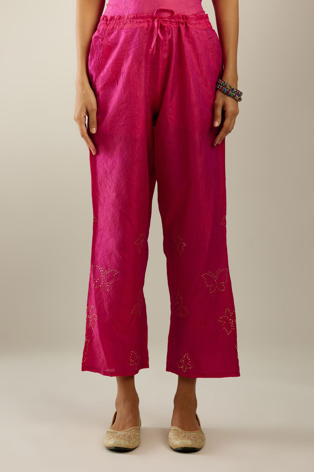 Raspberry crushed silk pants with side pockets and assorted sequined butterflies till mid-calf length.