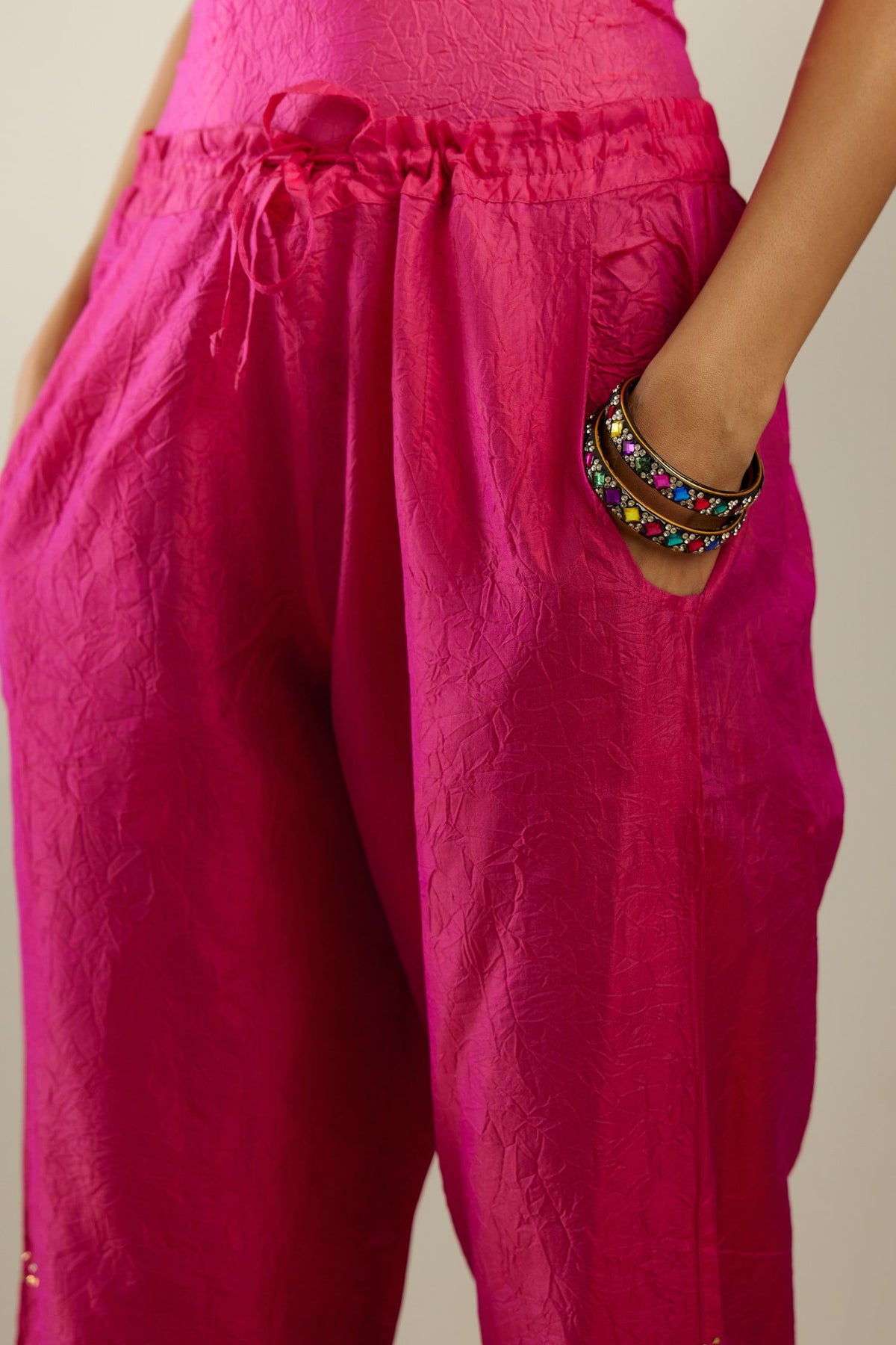 Raspberry crushed silk pants with side pockets and assorted sequined butterflies till mid-calf length.