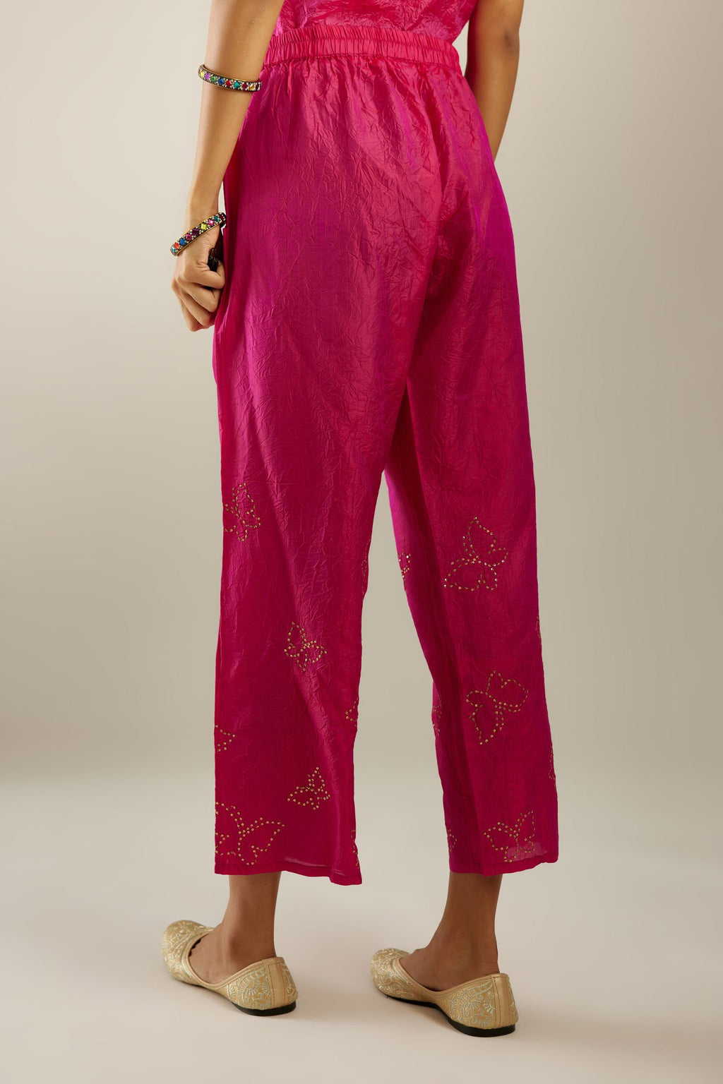 Raspberry crushed silk pants with side pockets and assorted sequined butterflies till mid-calf length.
