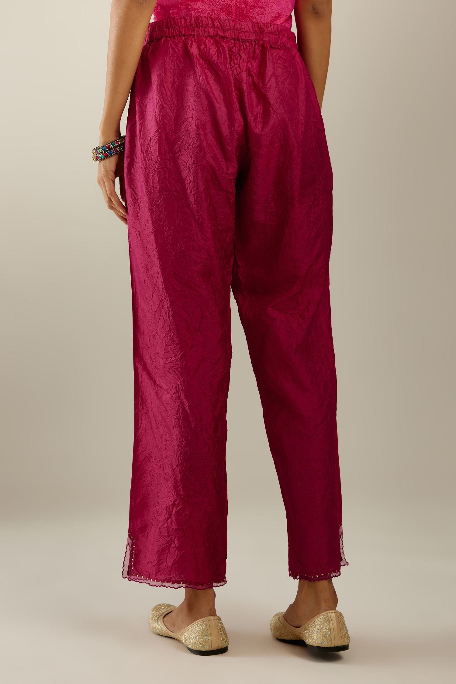 Raspberry hand crushed silk straight pants with scalloped and embroidered organza at edges and detailed with a single line of sequins at hem