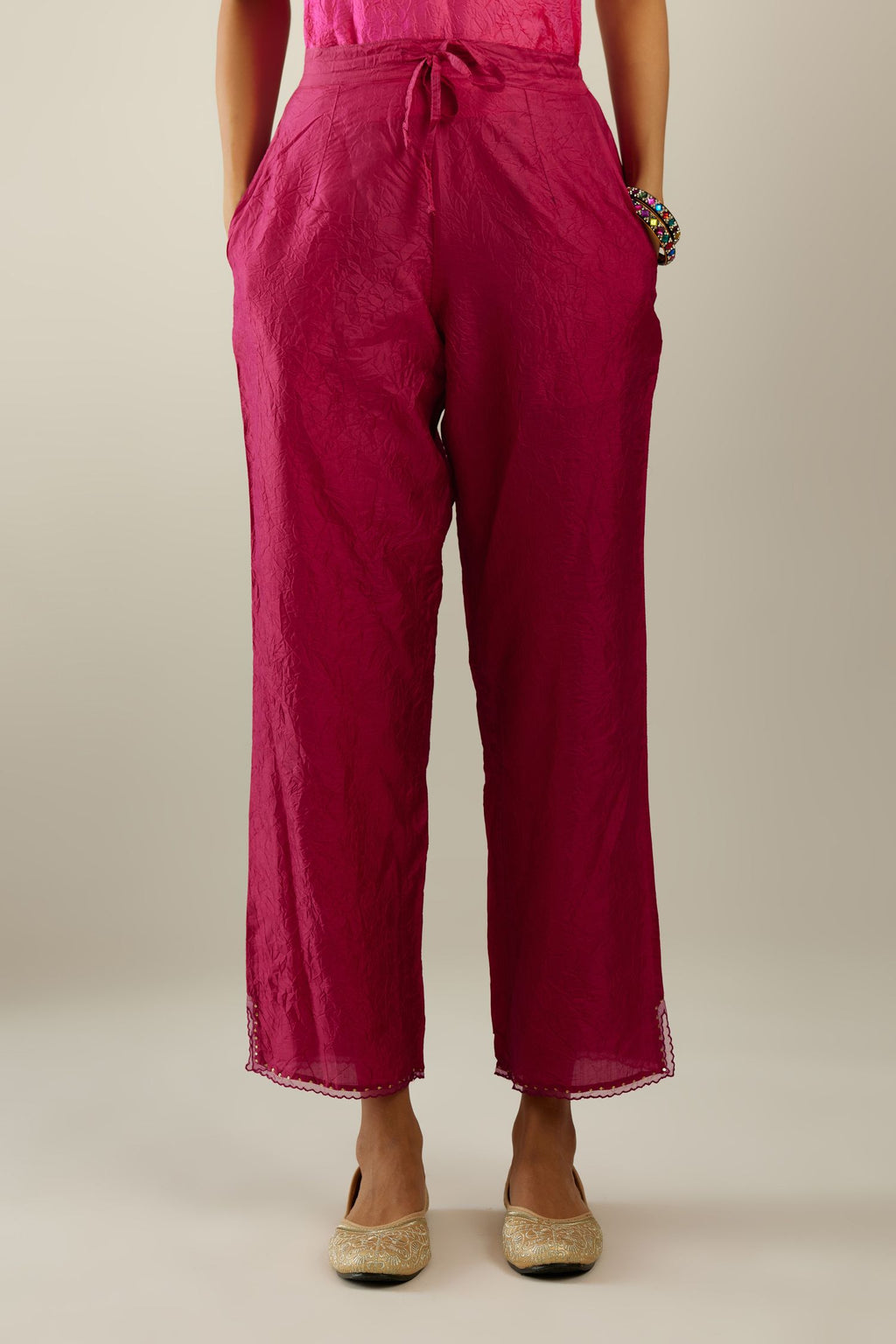 Raspberry hand crushed silk straight pants with scalloped and embroidered organza at edges and detailed with a single line of sequins at hem
