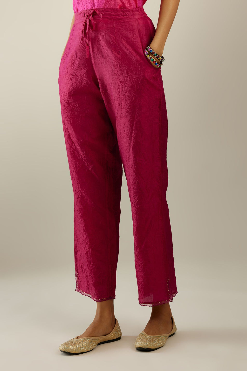 Raspberry hand crushed silk straight pants with scalloped and embroidered organza at edges and detailed with a single line of sequins at hem
