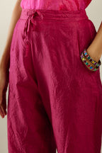 Raspberry hand crushed silk straight pants with scalloped and embroidered organza at edges and detailed with a single line of sequins at hem