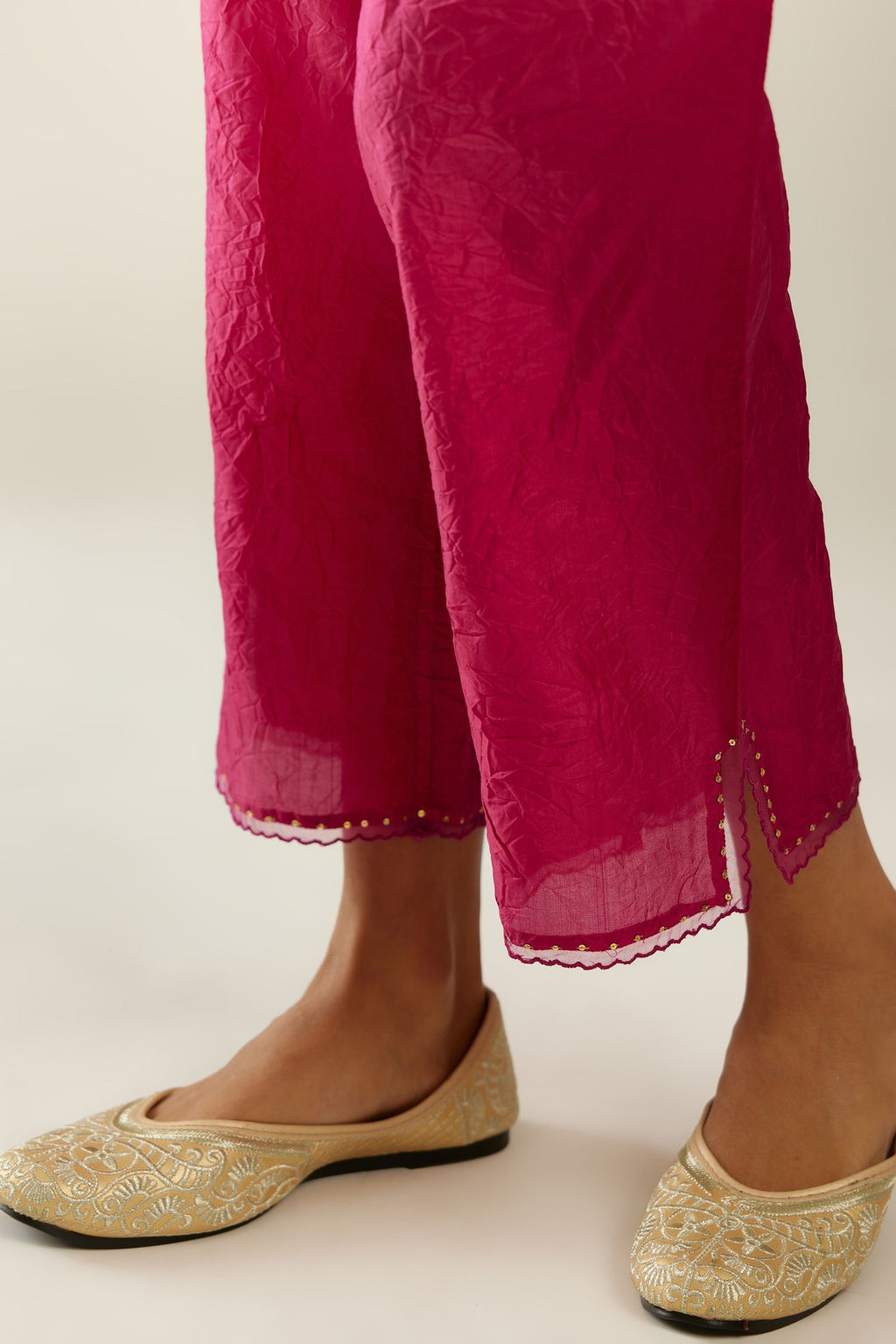 Raspberry hand crushed silk straight pants with scalloped and embroidered organza at edges and detailed with a single line of sequins at hem