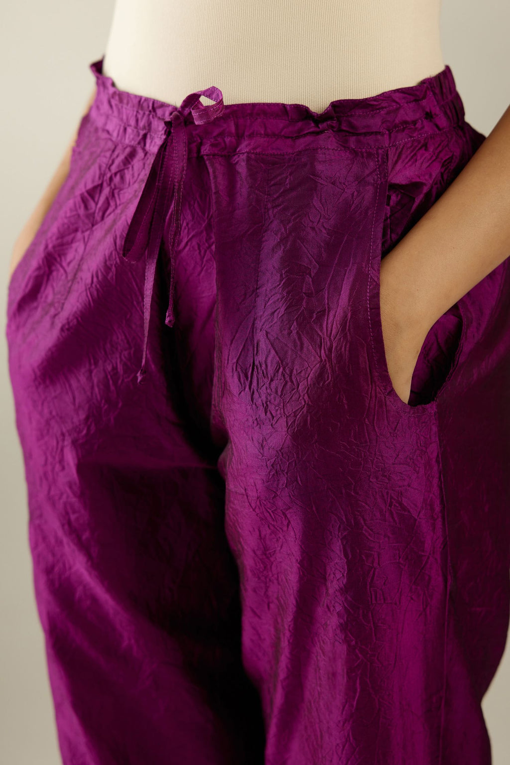 Sangria hand crushed silk pants with side pockets and assorted sequined butterflies till mid-calf length.