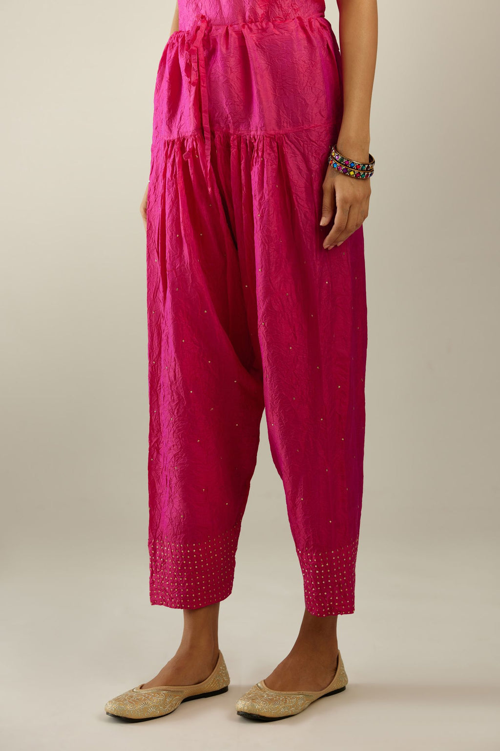 Raspberry hand crushed pure silk narrow salwar detailed with gold sequins at hem.
