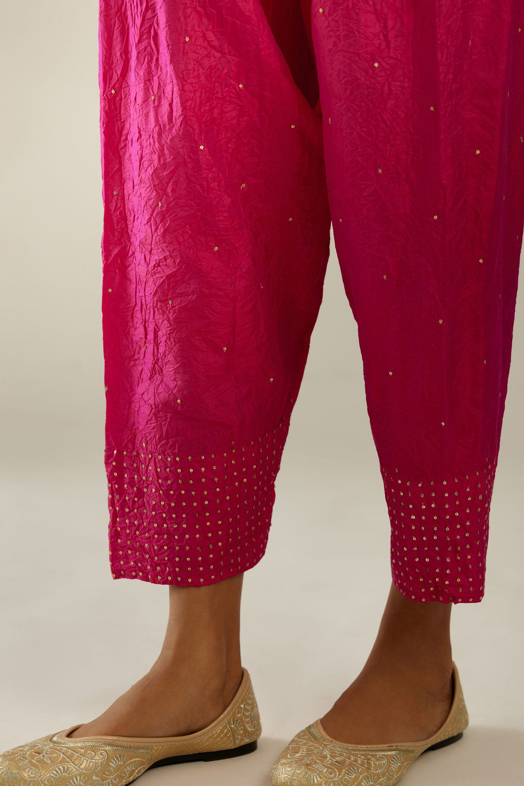 Raspberry hand crushed pure silk narrow salwar detailed with gold sequins at hem.