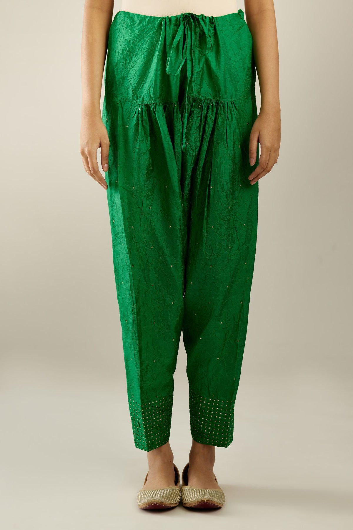 Grass green hand crushed pure silk narrow salwar detailed with gold sequins at hem.