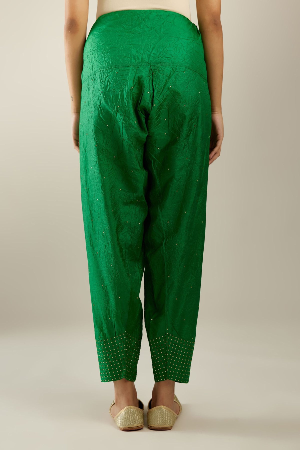 Grass green hand crushed pure silk narrow salwar detailed with gold sequins at hem.