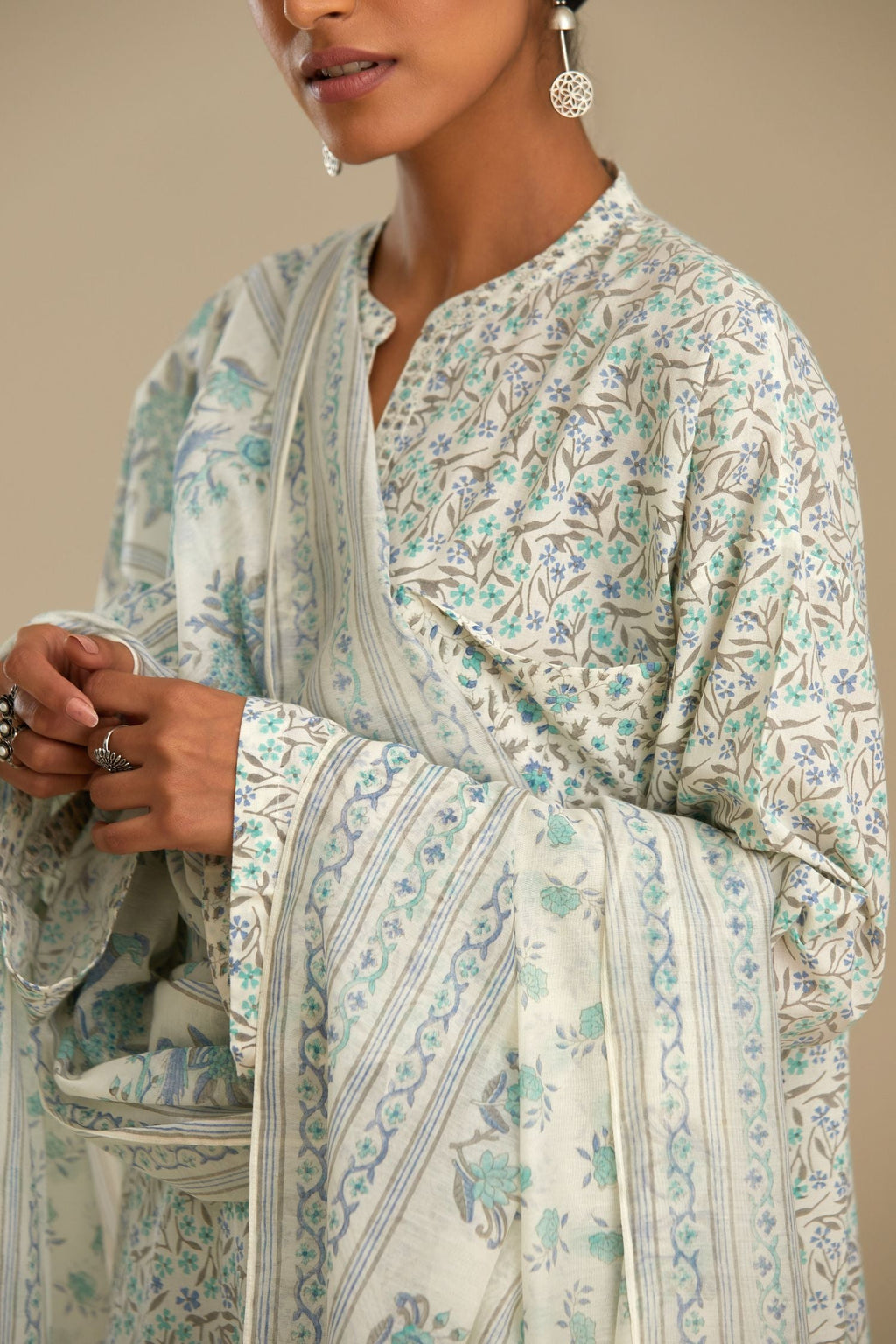 Blue printed cotton kurta set with front pockets and long sleeves.