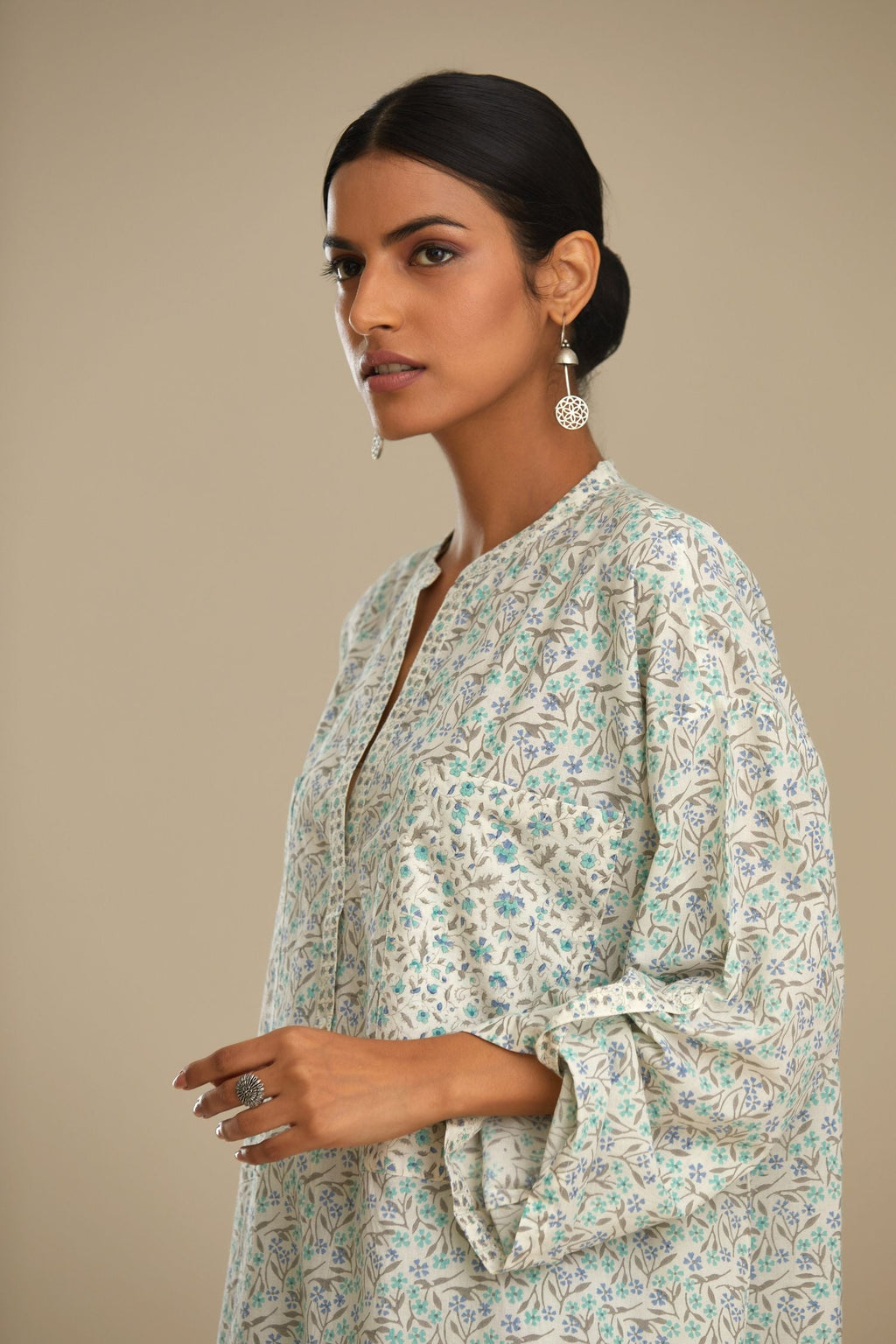 Blue printed cotton kurta set with front pockets and long sleeves.