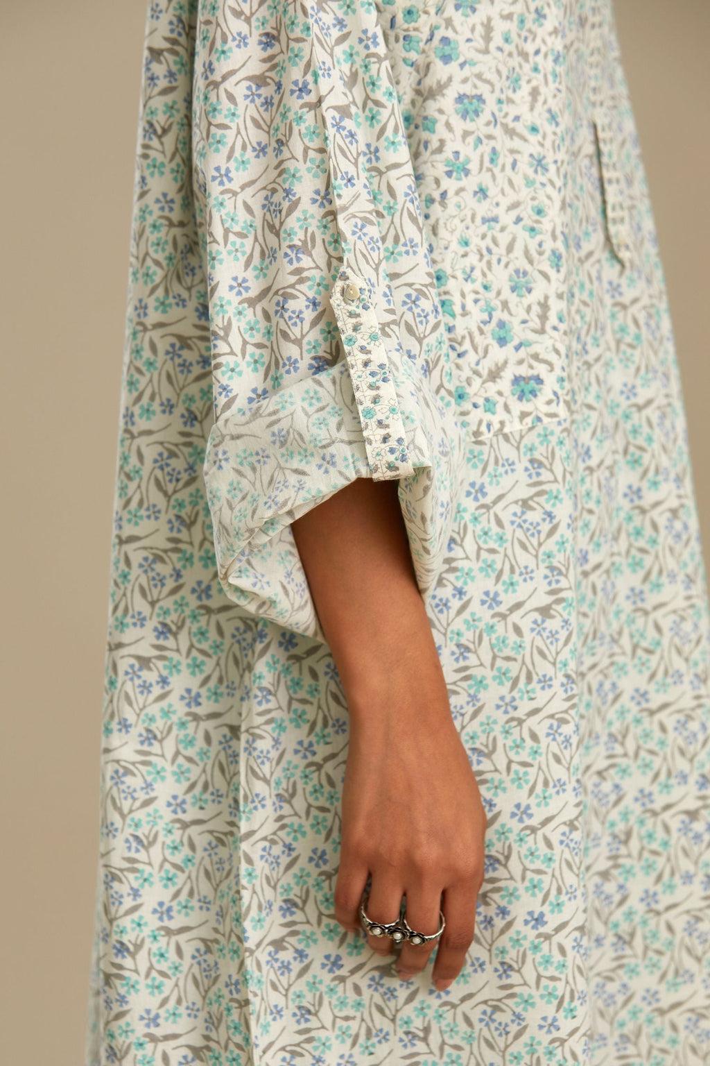 Blue printed cotton kurta set with front pockets and long sleeves.