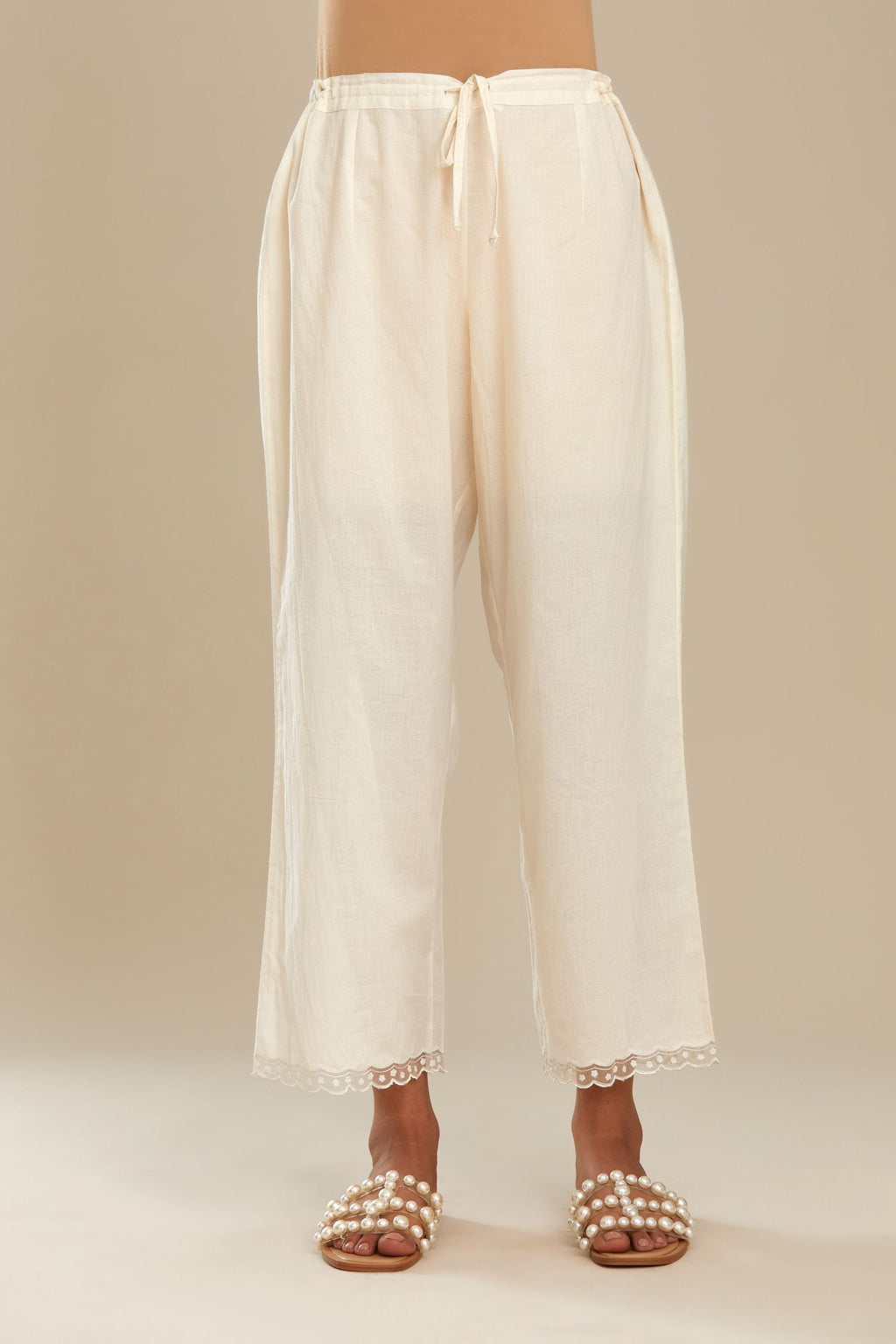 Off white straight pants with scalloped embroidery at bottom hem. (Pants)