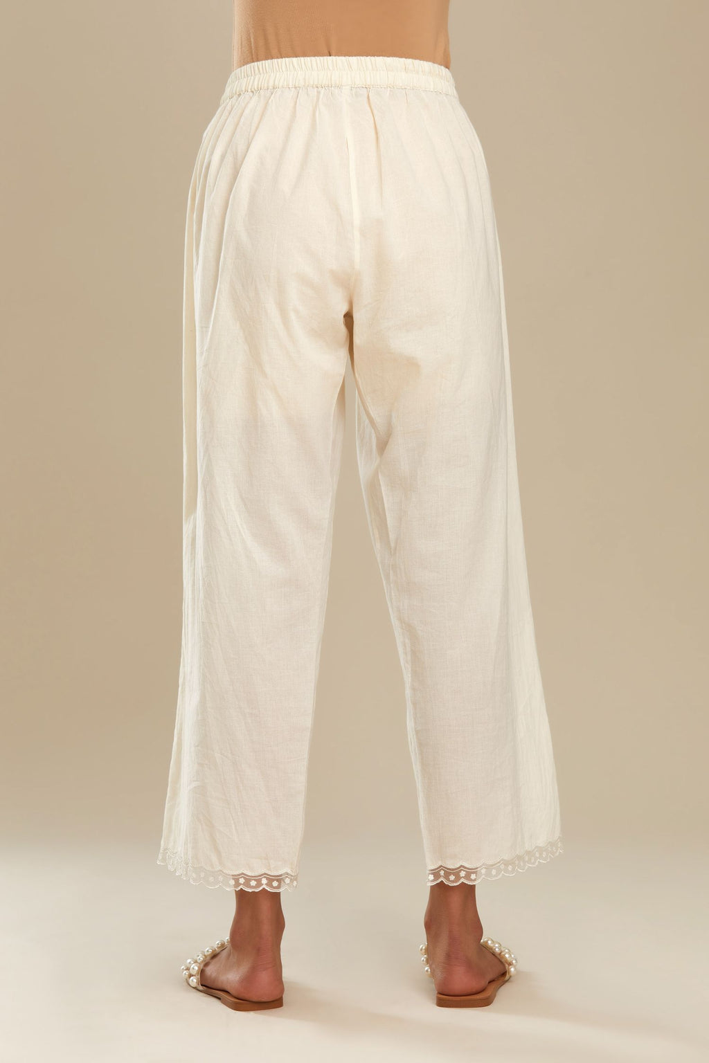 Off white straight pants with scalloped embroidery at bottom hem. (Pants)
