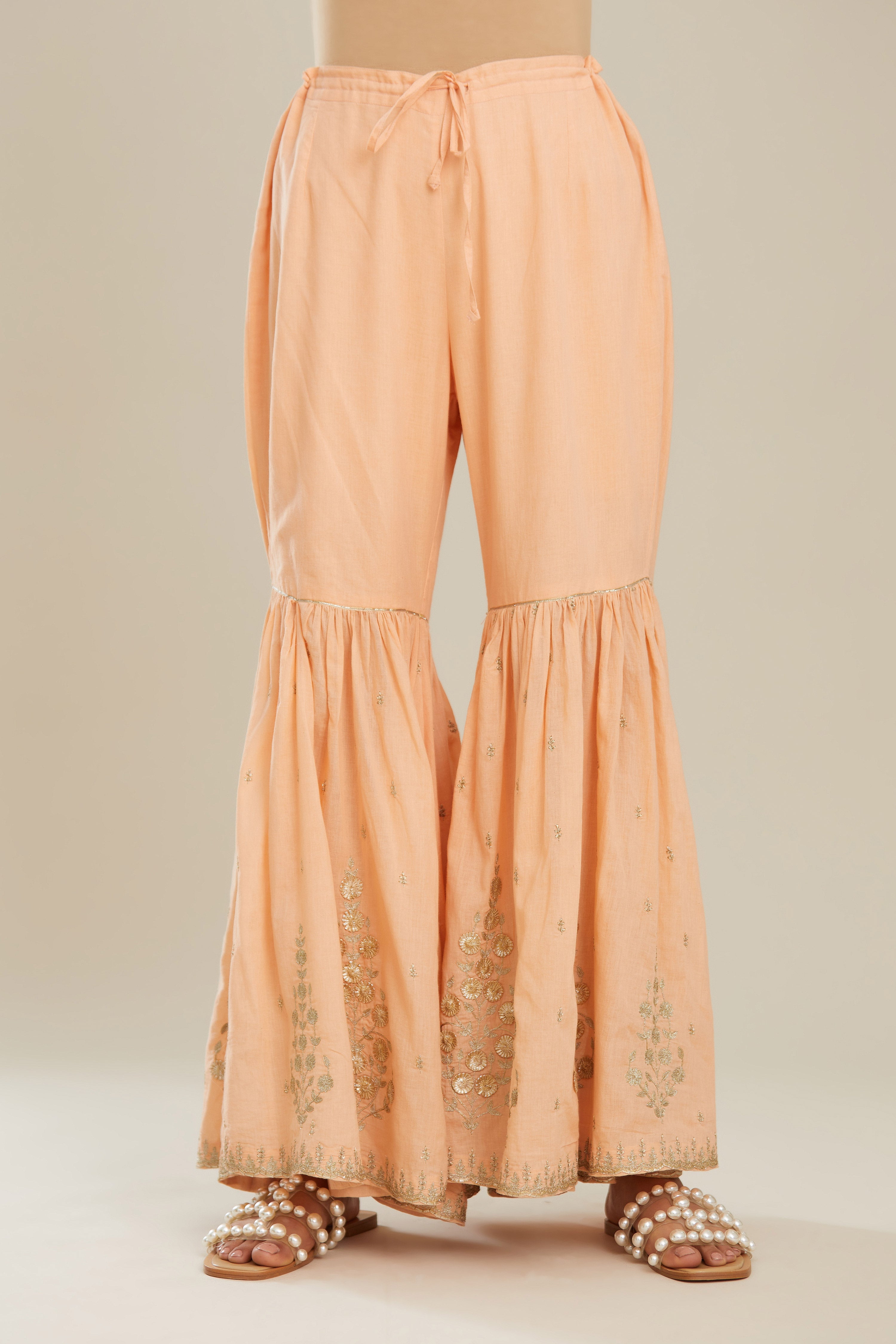 Peach farshi with gold zari and gota embroidery and gota detailing at knee joint seam. (Farshi)