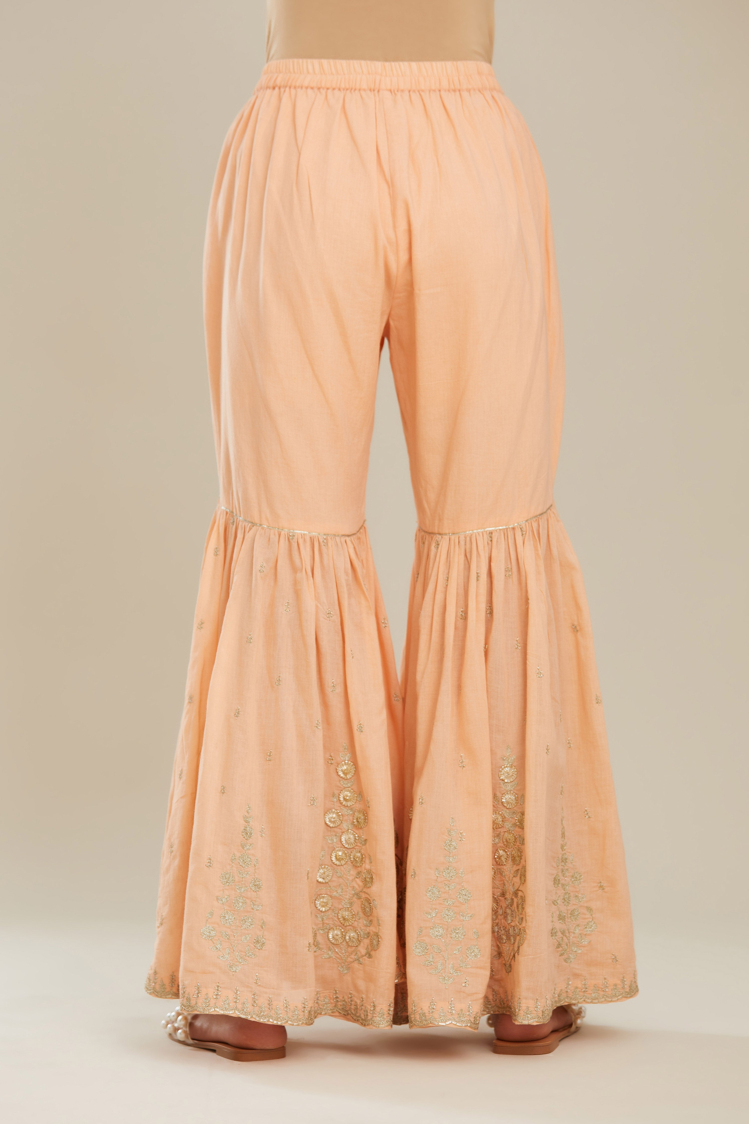 Peach farshi with gold zari and gota embroidery and gota detailing at knee joint seam. (Farshi)