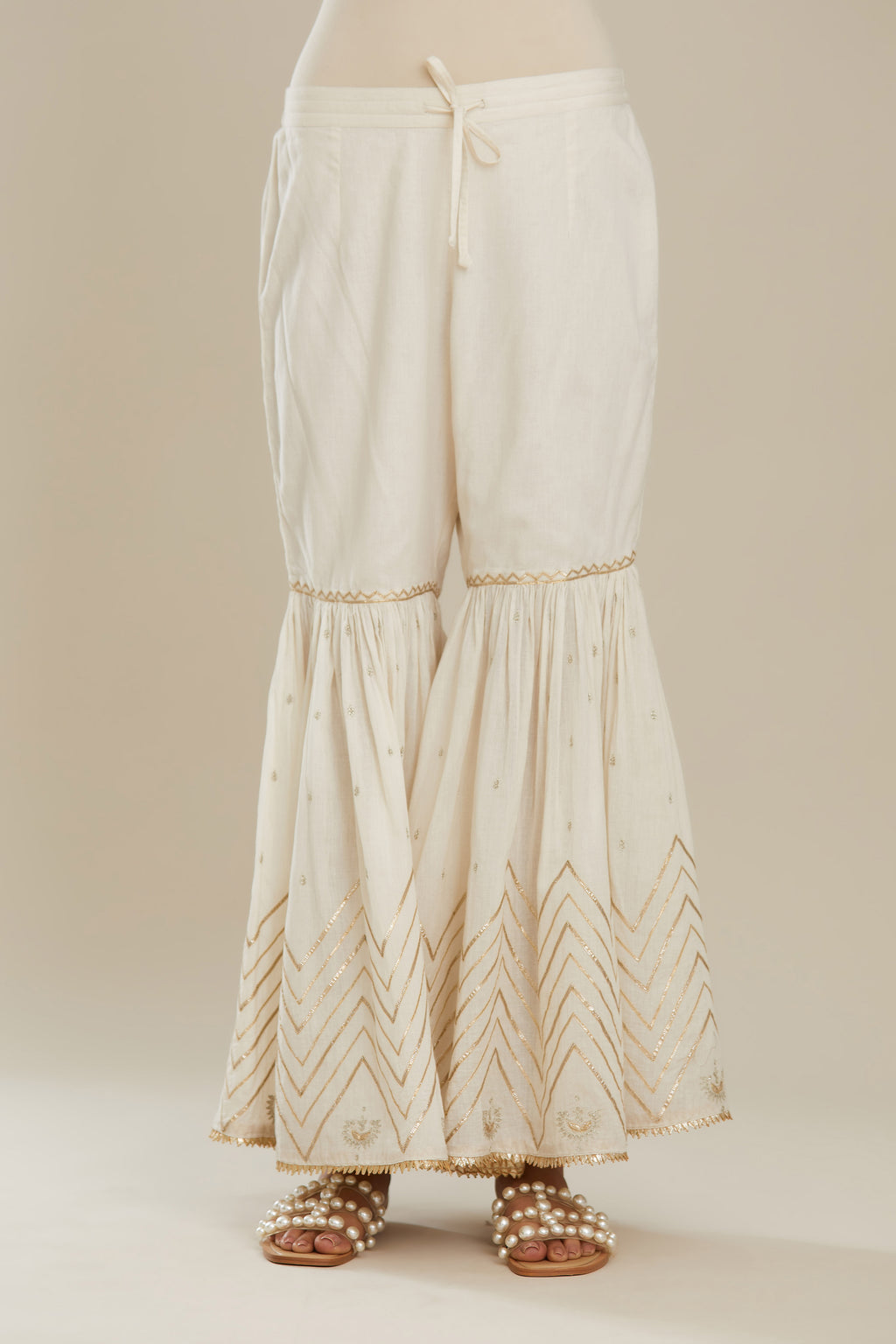 Off white farshi with gold gota work and gota patti lace at hem. (Farshi)