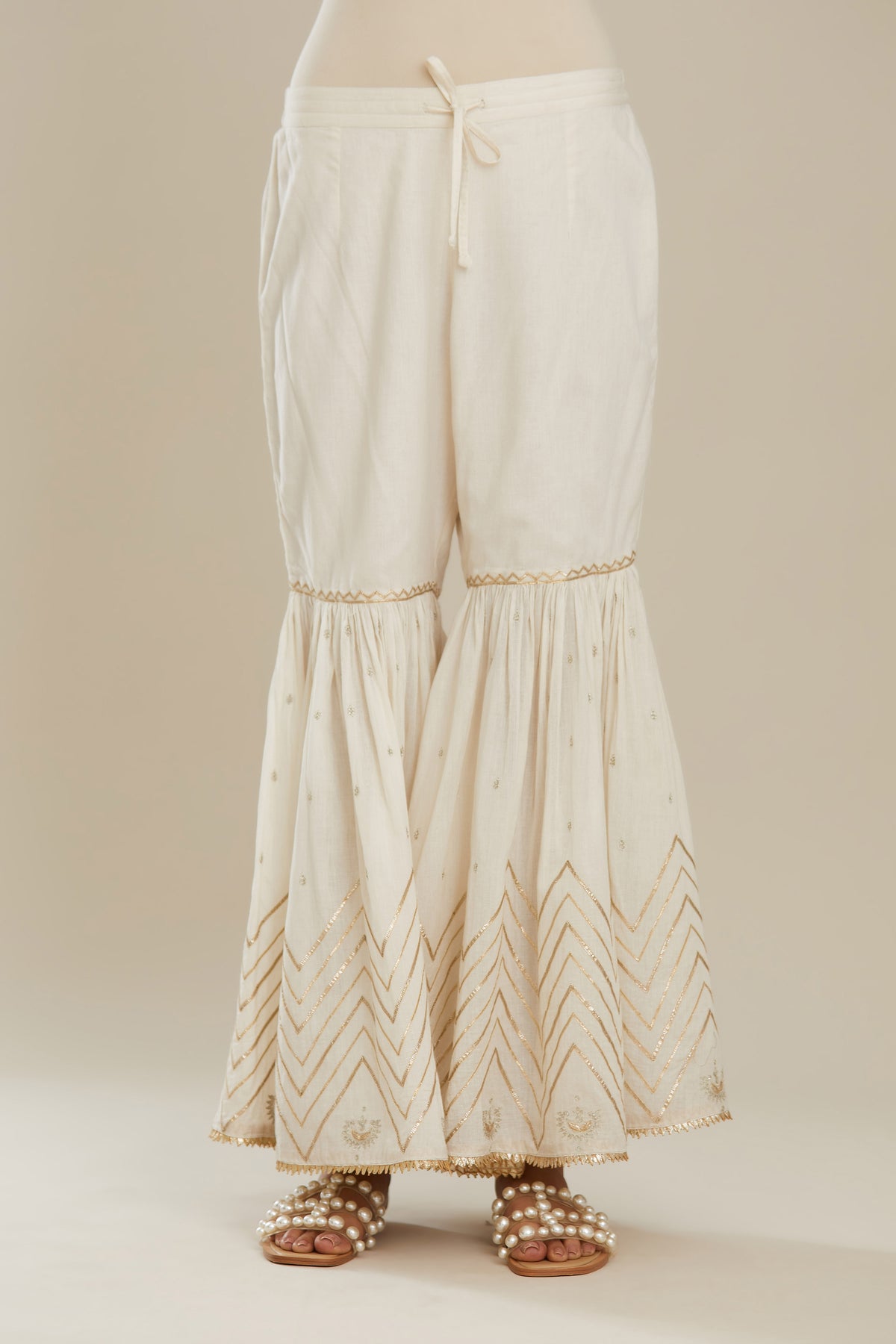 Off white farshi with gold gota work and gota patti lace at hem. (Farshi)