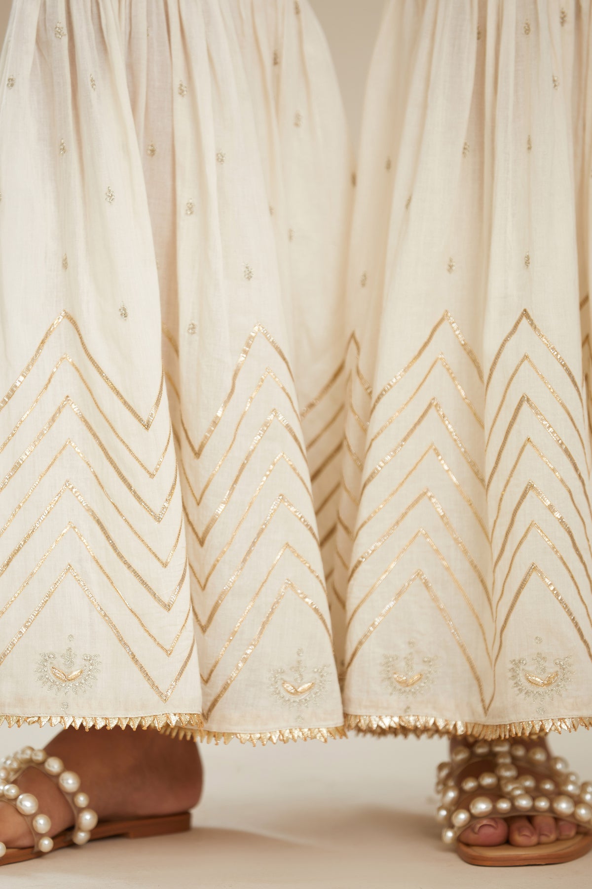 Off white farshi with gold gota work and gota patti lace at hem. (Farshi)