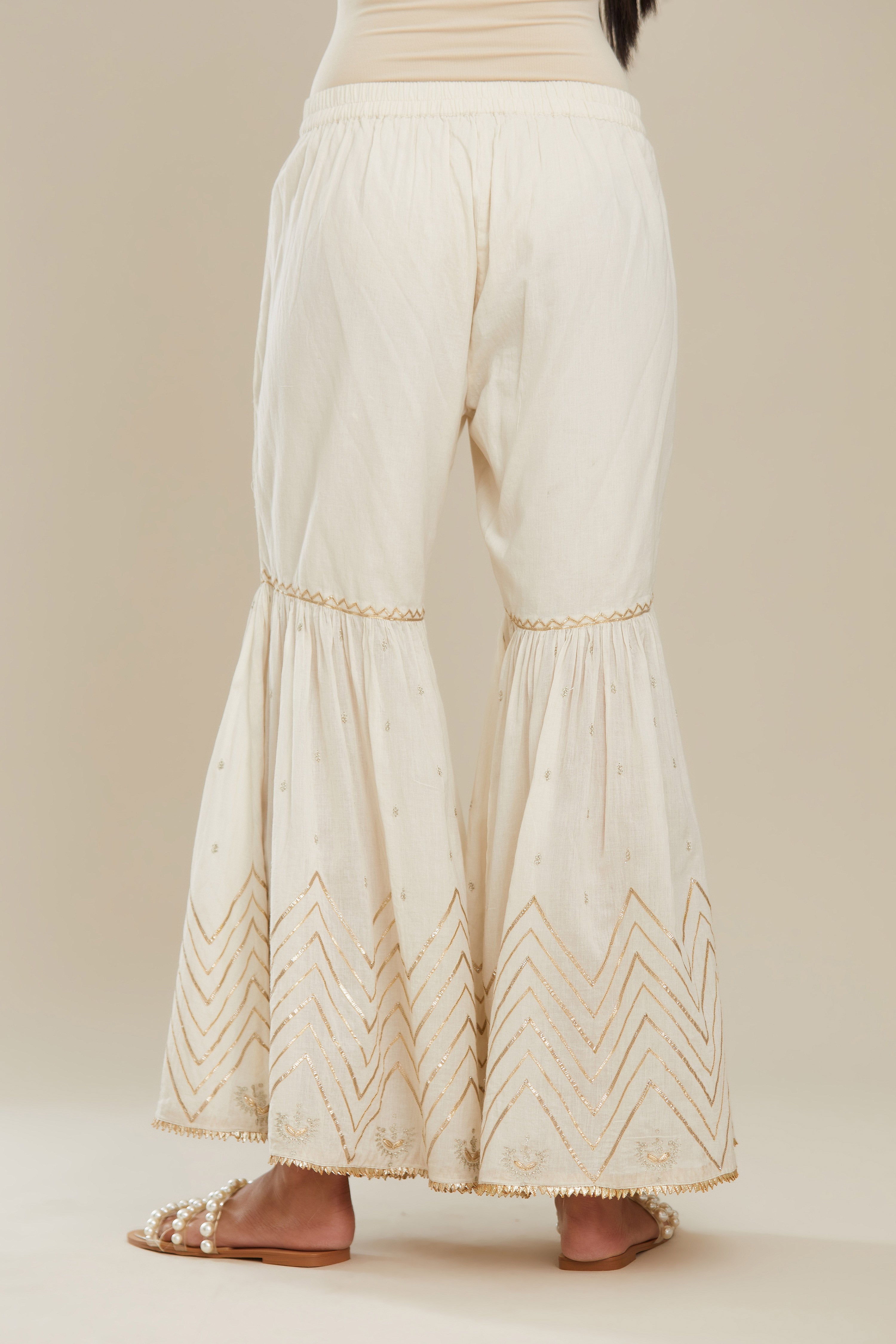 Off white farshi with gold gota work and gota patti lace at hem. (Farshi)