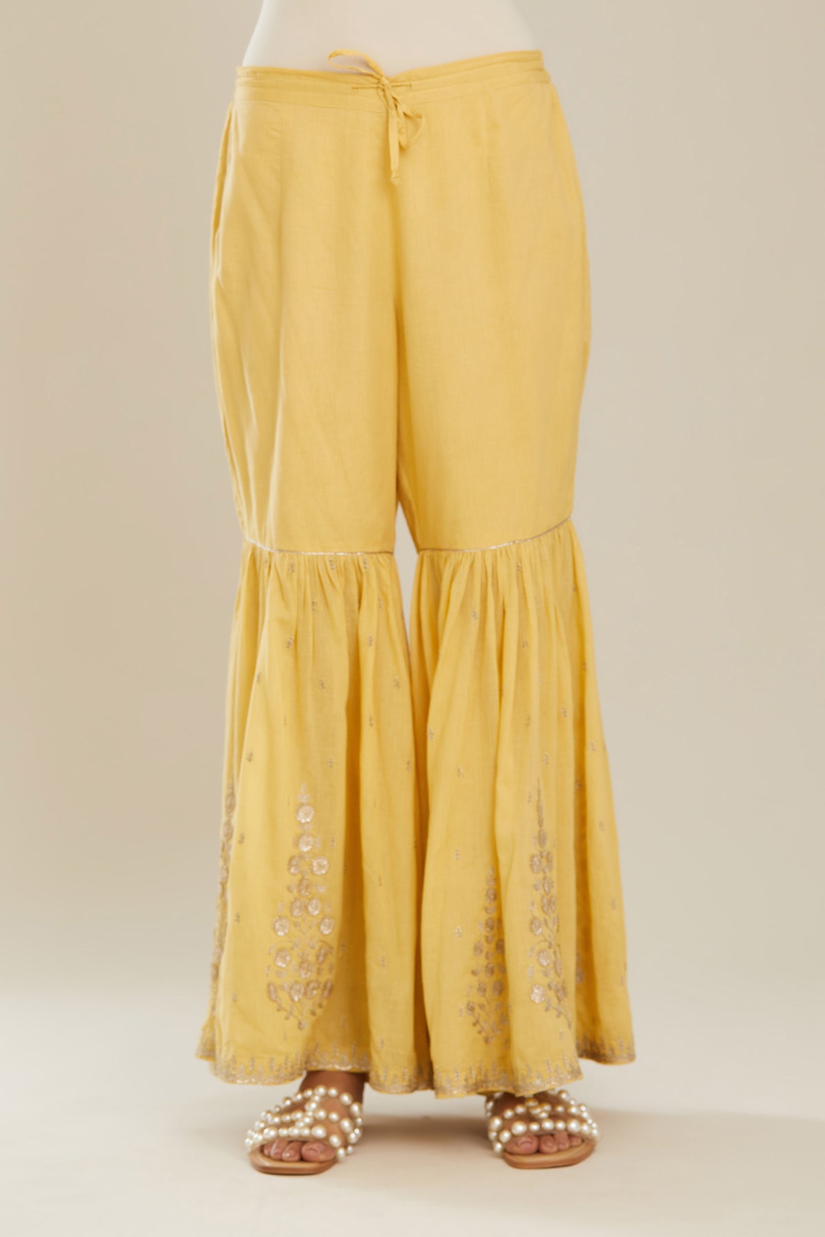 Yellow farshi with gold zari and gota embroidery and gota detailing at knee joint seam. (Farshi)