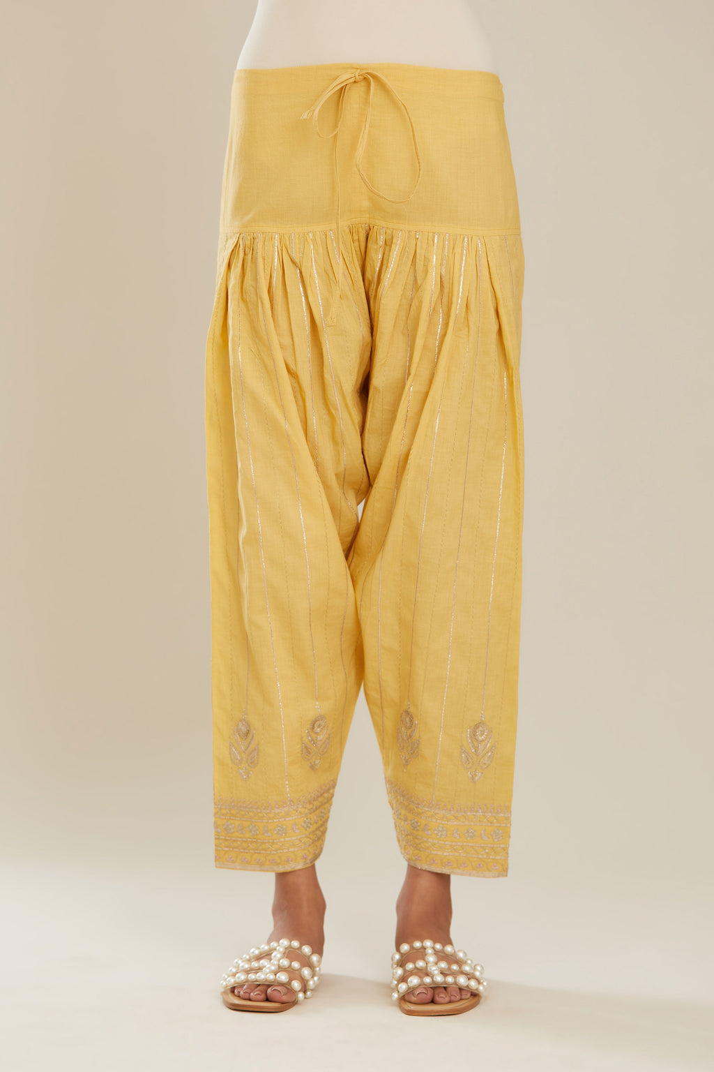 Yellow cotton narrow salwar with all-over gold gota and zari embroidery.