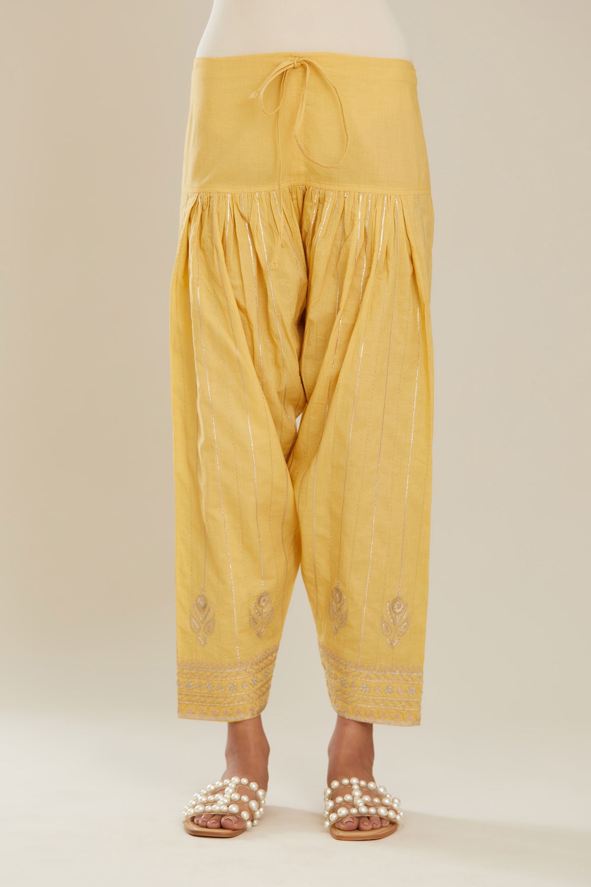 Yellow cotton narrow salwar with all-over gold gota and zari embroidery.