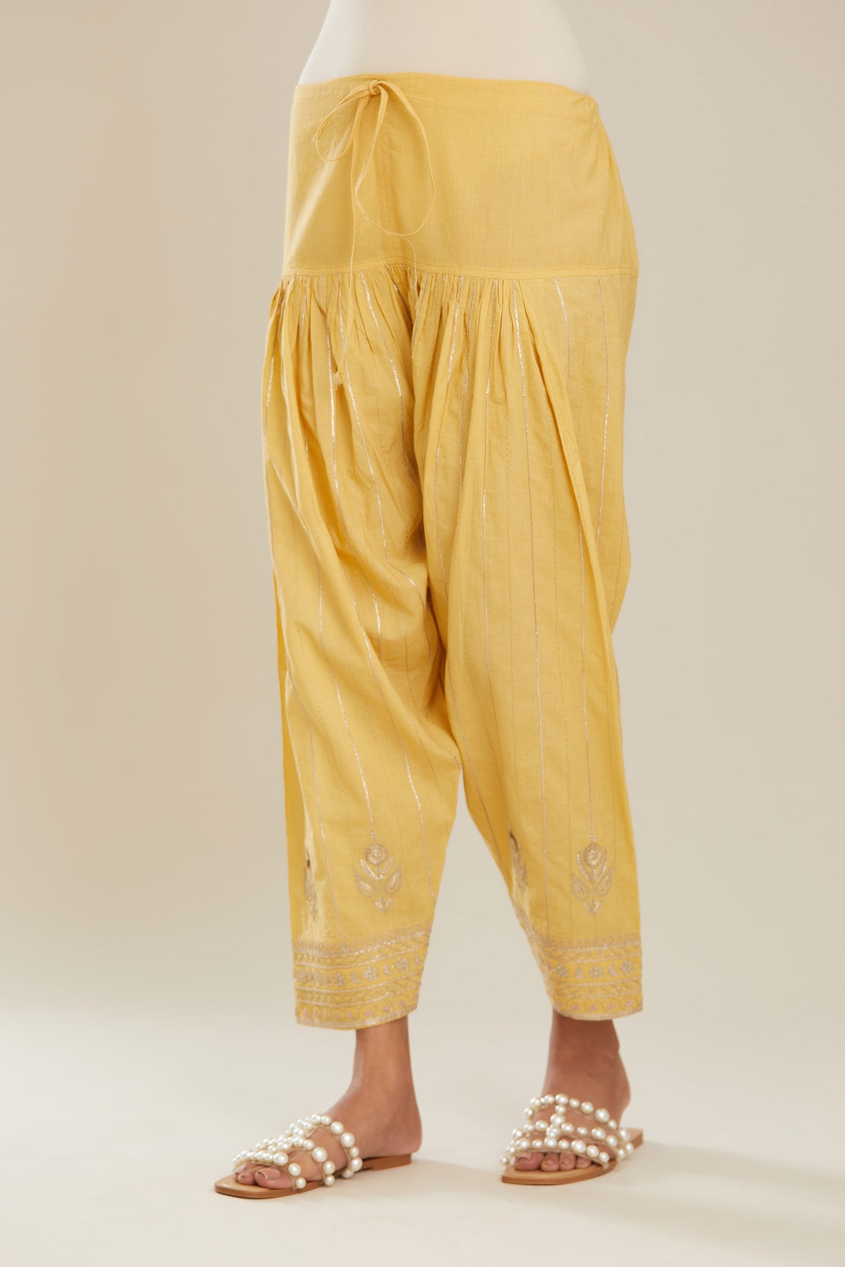 Yellow cotton narrow salwar with all-over gold gota and zari embroidery.